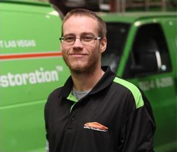 Male SERVPRO Technician with equipment as background