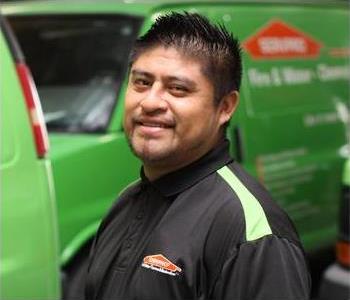 Male SERVPRO Technician with equipment as background