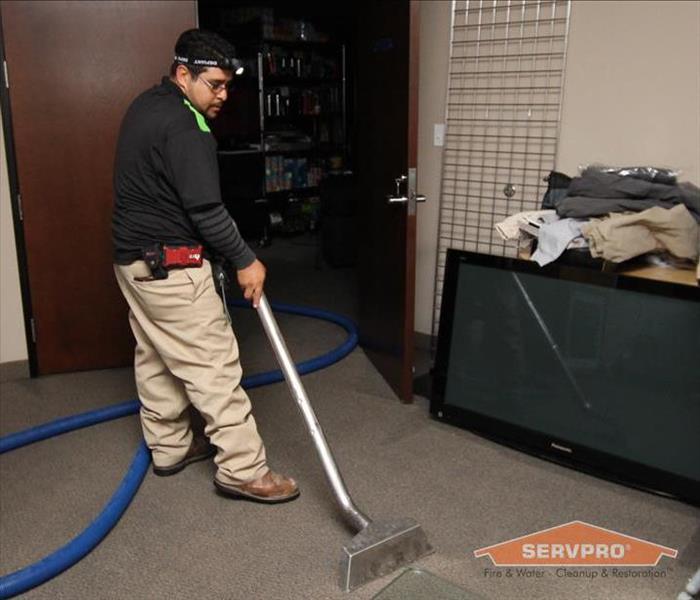 Extracting water from a carpet in a commercial building.