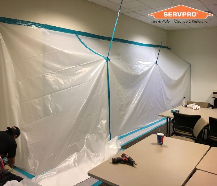 Setting up containment for mold remediation.